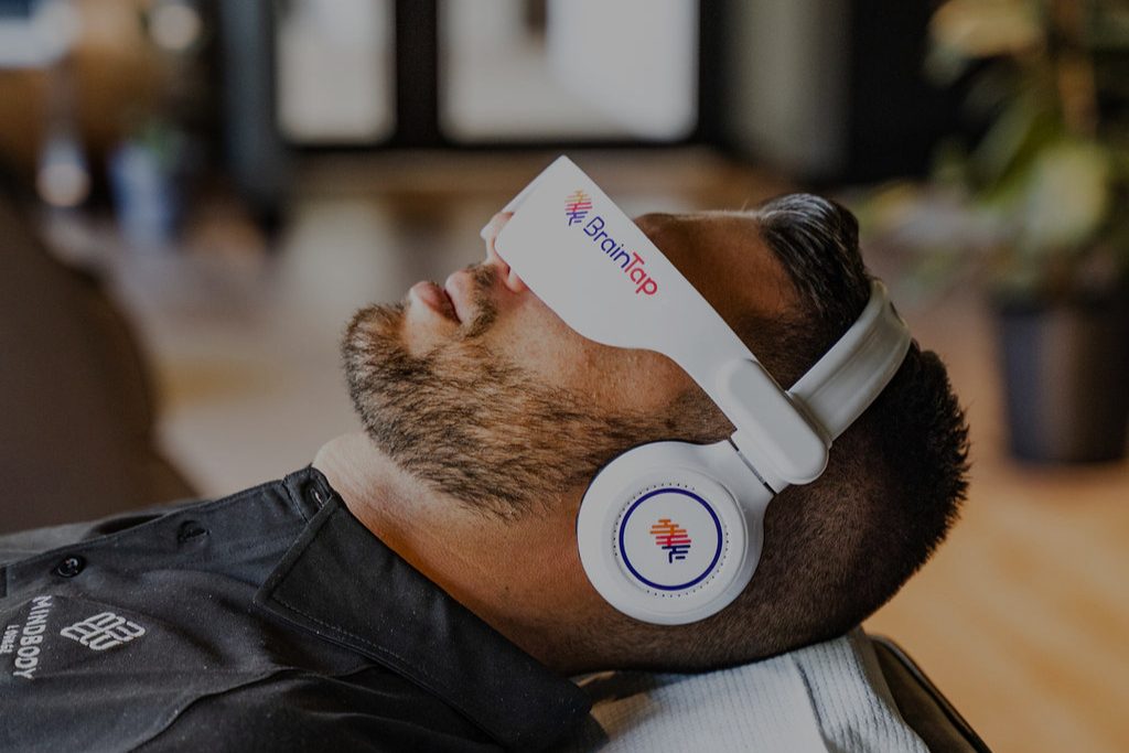 A client wearing the BrainTap headset at Mindbody Lounge, Victoria Park